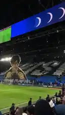 Witness the incredible fan culture at Al Hilal FC's home stadium. This video captures a massive, professionally designed tifo featuring a character from the famous manga 'Captain Tsubasa'. The crowd, dressed in blue and white, forms intricate patterns, while a large screen above displays animated crescent moons and the club's logo. It's a powerful display of team spirit and creative support. by @abood114 with Original Sound by abood114