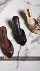 A close-up showcase of three pairs of DIANA brand women's high-heeled mule sandals. The video displays a black pair, a tan pair, and a brown pair, all featuring a distinctive cutout cage design on the footbed. A hand rotates the shoes to highlight their details against a marble background, with the DIANA shoebox visible. by @bydiana.co with 𝐟𝐥𝐨𝐲𝐲𝐦𝐞𝐧𝐨𝐫 < 🇪🇸🙂‍↕️💋! by Contains: Gata Only (Remix) - FloyyMenor and Ozuna and Anitta