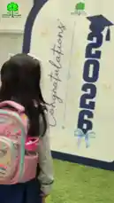 This heartfelt video captures a young student's journey through kindergarten at أجيال الفيصلية الأهلية. It begins with scenes of her first day, showing her learning to write and participate in class activities like tracing lines and identifying body parts. The narrative progresses to show her growth over time, culminating in a joyful celebration where she proudly stands before a 'Congratulations 2026' sign. The accompanying Arabic narration reflects on the challenges of starting school and the pride felt on graduation day. by @ajyalf with Original Sound by ajyalf