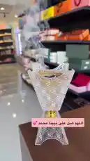 This elegant video tour explores a sophisticated store brimming with artisanal delights. It begins with a beautifully lit, smoldering incense burner, setting a serene mood before panning across shelves stocked with premium chocolates like Rolle Chocolat and Kate confections. The camera then showcases an array of high-end gift boxes and branded products, highlighting a curated selection perfect for gifting or indulgence. by @ch11.30 with اللهم اسالك الرضا by Tayf طيف
