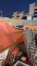 A close-up tour of vintage soccer memorabilia, including framed photographs of players shaking hands on the pitch and team group photos, found at a bustling market stall. A person narrates their discovery, identifying figures like 'Saud Al-Khelaifi' and 'Salah Al-Naima' and recalling a match from the late 70s or early 80s at Al-Masjid Al-Haram Stadium. by @hamed_aldaban with Original Sound by hamed_aldaban