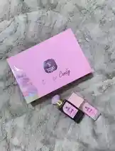 This video provides a top-down view of the new SOINS 'Ice Candy' product line, featuring its distinctive pink packaging and two items placed on a soft, grey textured surface. The camera slowly pans across the products, showcasing the brand's aesthetic. by @soins_sa with Original Sound by soins_sa
