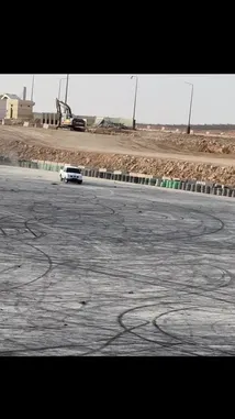 In a stunning display of vehicle control, فيصل 🥷🏻F expertly maneuvers his white pickup truck through a series of tight drifts on a vast, dusty proving ground. The truck leaves intricate tire marks across the terrain as it powers through the course, showcasing impressive handling and skill. by @zf_v81 with 😔✌🏻. by 2016