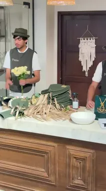 This video offers an intimate look inside 'The Gift Arts,' a creative space run by عبير ال زيدان. It showcases the meticulous process of crafting elegant gift packages using luxurious green velvet wraps and flowing beige ribbons, alongside beautiful floral arrangements. The footage transitions to the charming exterior and cozy interior of the shop, highlighting its modern aesthetic and artistic decor, providing a comprehensive view of the brand's unique style and craftsmanship. by @gift_arts1 with gift_arts1 by Original Sound