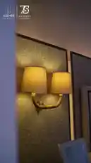 Explore the sophisticated interior design of a modern bedroom by Alemar Concept. This stylish space features a cozy bed adorned with plush grey fur pillows, a chic reading nook with books and a reed diffuser, and a luxurious vanity area highlighted by elegant wall sconces. Experience the warm ambiance created by thoughtful lighting and contemporary furnishings. by @alemarconcept with alemarconcept by Original Sound