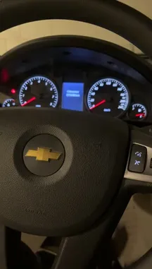 A close-up tour of a Chevrolet vehicle's interior, focusing on the instrument cluster displaying an odometer reading of 359,498 km. The camera pans across the steering wheel, speedometer, tachometer, and center console, revealing a partially disassembled dashboard with exposed wiring and a missing radio unit. A person wearing a blue glove briefly interacts with the console area. by @khllo17 with Original Sound by khllo17