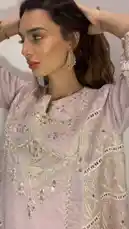 A model showcases a stunning light pink Anarkali suit, highlighting its intricate gold embroidery, delicate cutwork sleeves, and graceful drape. She poses and turns to display the outfit's front, side, and back details, offering a comprehensive look at this beautiful traditional attire. by @needle_t with original sound