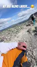A bearded man in a white hoodie and cap, identified as 'Viking Custom Craft', shares his experience hiking across a vast, rocky plateau under a bright blue sky. He narrates his thoughts on the ease of descending compared to climbing, while the camera captures the expansive Norwegian landscape. This personal vlog offers insight into mountain trekking and the unique challenges of high-altitude trails. by @vikingcustom with Original Sound by vikingcustom