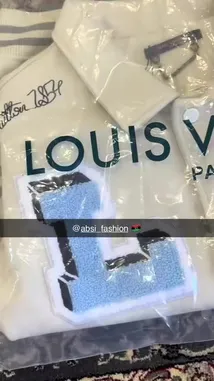 A close-up tour of a unique Louis Vuitton varsity jacket featuring 'LOUIS' lettering, Looney Tunes characters like Bugs Bunny, and classic collegiate details. This stylish piece blends luxury branding with playful pop culture elements. by @absi_fashion with absi_fashion by Contains: Baba - Amr Diab