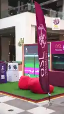 Experience the vibrant atmosphere of the Qatar Stars League's official launch event. This energetic showcase features traditional Qatari culture with men in thobes, exciting football-themed activities for children, and lively entertainment including mascot performances and a magician. The event highlights fan engagement through photo opportunities with players and interactive games, all set against the backdrop of modern Qatari architecture and festive purple lighting. by @qsl with Original Sound by qsl