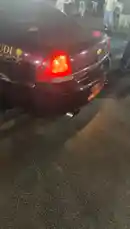 In a vibrant night scene, M's customized dark maroon Chevrolet Impala takes center stage. With 'SAUDI NATIONAL DAY' proudly displayed on its side, the car performs a powerful exhaust note, its dual pipes roaring to life. A crowd gathers around, captivated by the raw sound and the vehicle's striking presence under the city lights. by @mo_kbs8 with Original Sound by mo_kbs8