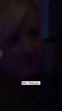 A close-up performance of Sabrina Carpenter singing her song 'My Tea Is Gone Cold.' She wears a black and white striped shirt under purple and blue stage lights. Lyrics are displayed on screen in English and Arabic. by @c0_hn with Original Sound by Contains: Thank You ((Acoustic) [Live]) - Dido
