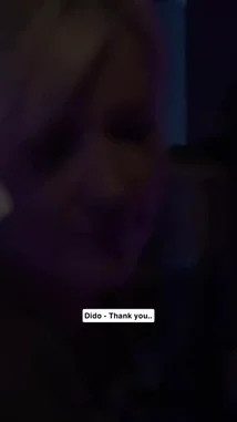 A close-up performance of Sabrina Carpenter singing her song 'My Tea Is Gone Cold.' She wears a black and white striped shirt under purple and blue stage lights. Lyrics are displayed on screen in English and Arabic. by @c0_hn with Original Sound by Contains: Thank You ((Acoustic) [Live]) - Dido
