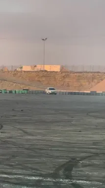 In a stunning display of automotive skill, فيصل 🥷🏻F takes his white pickup truck for a high-octane drift session on a dusty, open-air track during golden hour. The vehicle performs wide, controlled slides, kicking up thick clouds of dust and smoke as it weaves around the course. The arid landscape and dramatic lighting create a cinematic atmosphere, showcasing both the power of the truck and the driver's precision. by @zf_v81 with Original Sound by zf_v81
