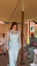 This video captures a heartfelt moment from Iman Sophie Koloff's wedding day, where she prepares traditional Turkish coffee for her fiancé. The scene unfolds outdoors under a tent, showing her in a stunning light blue sequined dress making coffee on a portable stove with friends and family. She then serves it to her fiancé, who is seated and dressed in a white suit. The video includes a brief flashback to a kitchen setting, suggesting preparation, and ends with a collage of photos from their relationship, highlighting the significance of this cultural ritual. by @imsemdiary with Original Sound by imsemdiary