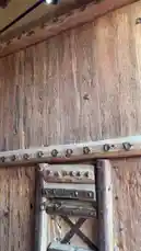 This close-up video tour explores a massive, ancient wooden door, believed to be the very entrance used by King Abdulaziz. The camera focuses on its weathered texture and intricate details, including a small embedded iron piece identified as a 'Ras al-Harba' (War Head). A narrator provides historical context, enhancing the viewer's understanding of this significant artifact. by @hamed_aldaban with Original Sound by hamed_aldaban