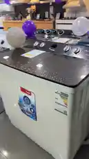 A hands-on walkthrough of a new Olsemark twin-tub washing machine in a retail store. The presenter highlights its large capacity, features like 'Super Wash', and points out the price tag of 960 SAR, noting it's a good deal compared to its previous price of 1499 SAR. The video shows the machine's interior drum, control panel, and overall design. by @dalilnet with Original Sound by dalilnet
