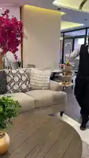 A server presents an elegant afternoon tea service at Armada Residence. The scene showcases a beautifully arranged three-tiered stand filled with sandwiches, scones, jams, and assorted pastries, accompanied by a traditional teapot and cups. The warm ambiance, featuring a fireplace and stylish decor, creates a sophisticated and inviting atmosphere perfect for a relaxing tea time. by @armadar25 with armadar25 by Original Sound