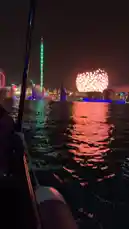 Experience the vibrant night view of Dubai Parks and Resorts from a boat. The camera captures the illuminated skyline, including the iconic Ain Dubai observation wheel and other attractions like the roller coaster and water park, all reflected beautifully on the water. This scenic tour offers a unique perspective of the entertainment destination after dark. by @guruofmarketing with Original Sound by guruofmarketing
