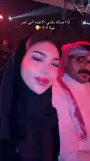 Join سوجا ديزاين🍉 as she captures the vibrant energy of a bustling night event in Saudi Arabia. Dressed in a stylish black abaya, she shares a moment of joy with a companion in traditional thobe and ghutra under dazzling red lights. With Arabic text overlay expressing excitement, this selfie-style video offers a personal glimpse into modern social life and cultural experiences. by @soja_design with Soj by Sssss