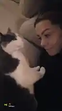 In a heartwarming display of pet affection, Zagvik cuddles closely with her gray and white cat on a cozy couch. The cat playfully licks her face and nuzzles into her neck, showcasing their deep bond. This intimate, real-life moment captures the simple joy of companionship between a pet owner and her beloved animal. by @zagvik with 🐴 by Contains: Look At That Woman - ROLE MODEL