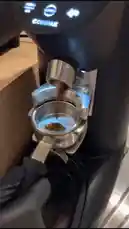 A barista at Sequence Coffee demonstrates the art of espresso extraction. The process begins with grinding fresh coffee beans into a portafilter using a Compak grinder. The portafilter is then locked into an espresso machine, and a rich, golden espresso shot is pulled into a white ceramic cup. The final scene reveals the elegant interior of the Sequence Coffee shop, featuring modern decor, floral arrangements, and a display of baked goods. by @sequence-coffee with 🤎🤎🤎🎻 by .