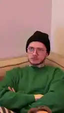 In this short, candid clip from Sommarkatten, three friends are seen lounging on a couch. The central figure, wearing a green sweater and black beanie, speaks directly to the camera about his lack of metro tickets, expressing his nervousness about the situation. His friends listen as he explains his plan to get around without one. The relaxed, conversational atmosphere captures a slice-of-life moment. av @sommarkattens med Original Sound av sommarkattens