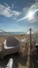 Experience a serene beachside moment with a white lounge chair, ocean views, and golden sunlight. This peaceful scene captures the essence of summer relaxation and outdoor leisure. Whether you're planning your next vacation or seeking inspiration for a calm getaway, this view offers a refreshing visual escape. by @tershine with original sound