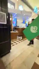 A person carries a large green sign with a white logo through a building and onto a train platform. They attempt to use it at a turnstile, but are stopped by staff wearing yellow vests. by @fabsvo with Original Sound by fabsvo
