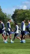 A group of Inter Milan football players are shown warming up during a training session on a sunny day. They jog across the grassy field, perform dynamic stretches, and engage in light drills using cones. The team is dressed in their blue and white training kits, with the Inter Milan logo visible throughout the footage. by @interofficial with Original Sound by Contains: Can't Hold Us (feat. Ray Dalton) - Macklemore, Ryan Lewis, Macklemore & Ryan Lewis