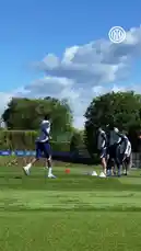 A group of Inter Milan football players are shown warming up during a training session on a sunny day. They jog across the grassy field, perform dynamic stretches, and engage in light drills using cones. The team is dressed in their blue and white training kits, with the Inter Milan logo visible throughout the footage. by @interofficial with Original Sound by Contains: Can't Hold Us (feat. Ray Dalton) - Macklemore, Ryan Lewis, Macklemore & Ryan Lewis