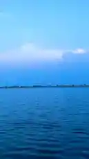 A tranquil, cinematic view of a vast lake under a deep blue sky, captured by Salman🤍. The camera glides across the water, reflecting the soft glow of a setting sun on a large, puffy cloud. This peaceful scene is perfect for relaxation, meditation, or finding inspiration. by @salmanx360 with salmanx360 by Original Sound