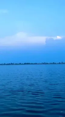 A tranquil, cinematic view of a vast lake under a deep blue sky, captured by Salman🤍. The camera glides across the water, reflecting the soft glow of a setting sun on a large, puffy cloud. This peaceful scene is perfect for relaxation, meditation, or finding inspiration. by @salmanx360 with salmanx360 by Original Sound
