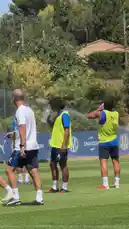 In this humorous scene, players from Olympique de Marseille are seen relaxing on the training pitch during a heatwave. One player has a comically large ice cube digitally placed on his head, which he uses to mock the sweltering conditions. The playful prank highlights the team's camaraderie and provides a light-hearted moment amidst their rigorous summer training. by @omofficial with Original Sound by omofficial