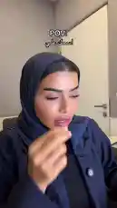 A woman in a dark blue hijab and abaya speaks directly to the camera, narrating a story about a man named Ali. She describes him as incredibly charismatic, sociable, kind, and someone who effortlessly wins everyone over. Her expressive gestures and the on-screen text 'POV: اسمك علي' ('POV: Your name is Ali') suggest she is embodying his perspective, sharing the experience of being this universally liked and charming person. by @soldere.ledyafa with Original Sound by soldere.ledyafa