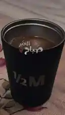 This short-form content features a close-up of a black travel mug filled with coffee, accompanied by Arabic text overlays reading 'Good morning' and 'Every morning, tell your heart it's worth the wait.' A male voice narrates the same message over gentle background music. The creator, سوليدير للمناسبات و الضيافة ✪, presents a simple yet powerful morning affirmation. by @soldere.ledyafa with Original Sound by soldere.ledyafa