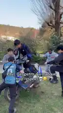 In a tense park setting, a group of young men confronts another individual near a motorcycle. What starts as a heated argument quickly escalates into a physical altercation, culminating in a chase. The on-screen text 'Pov: Ces petits qui manque trop respect' (Point of View: These little ones who lack too much respect) frames the incident as a cautionary tale about disrespect and its consequences. by @izerflyy with Original Sound by izerflyy