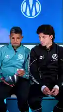 Two Olympique de Marseille footballers, wearing their team tracksuits, participate in a lighthearted Q&A about the Argentina national team. They discuss their fondest memories, including debuts and World Cup victories, as well as their toughest moments like being eliminated from the Olympics. The conversation includes trivia about Argentina's World Cup history and reveals who they consider their best friend in the dressing room. by @omofficial with Original Sound by omofficial