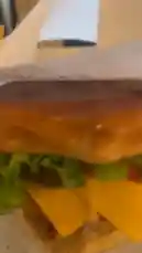 A mouthwatering close-up of a perfectly crafted crispy chicken cheeseburger layered with fresh lettuce, juicy tomato, and melted cheddar, served alongside a basket of golden, seasoned French fries. This appetizing meal presentation highlights delicious textures and vibrant colors, ideal for food lovers seeking satisfying fast-casual eats. by @be_food with be_food by Original Sound