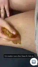 Watch as Sana K® Paris demonstrates her personal hair removal technique using a golden-colored wax strip. This close-up tutorial shows the application and swift removal process on the leg, highlighting her signature method for achieving smooth skin. The on-screen text 'Un rendez vous chez Sana K c'est ça' translates to 'A meeting at Sana K is like this,' positioning this as a glimpse into her professional beauty services. by @sanakparis with original sound