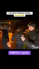This nighttime video captures streamer IZER and his crew on a wet street, seemingly preparing for a prank or challenge involving the phrase 'On dirait Gradur Prime'. The atmosphere is tense as they interact with another individual before one person suddenly runs away, suggesting the situation took an unexpected turn. The scene is illuminated by streetlights, creating a dramatic effect. by @izerflyy with Original Sound by izerflyy