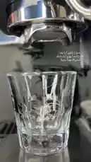 This close-up video demonstrates the process of brewing espresso using a professional machine. Viewers can see the rich, dark coffee extract flowing into a glass cup, showcasing the ideal crema and consistency. The accompanying Arabic text offers tips on achieving the perfect shot, making it a valuable resource for coffee enthusiasts and professionals alike. by @soldere.ledyafa with Original Sound by soldere.ledyafa
