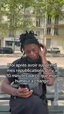 A woman sits on a bench outdoors, looking at her phone with a smile. On-screen text in French reads, 'Me after deleting my posts from it 10 minutes ago because my mood changed.' She then looks away thoughtfully, embodying the common feeling of changing one's mind about social media content. This scene captures a relatable moment of digital indecision. by @prmecc with Original Sound by prmecc