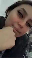 In this intimate selfie, Mia showcases her bold makeup look with dramatic winged eyeliner and voluminous lashes. She gently rests her chin on her hand, offering a playful and confident expression. Her dark hair frames her face perfectly, while subtle details like earrings and a stylish black top hint at her personal style. The soft lighting enhances her features, creating a warm and inviting atmosphere. This moment captures a relatable, beauty-focused aesthetic perfect for fans of lifestyle and fashion content. by @alonamia22 with original sound