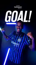 A player wearing Inter Milan's new blue and black striped jersey celebrates a goal with a triumphant pose under dramatic blue lighting. The word 'GOAL!' is displayed prominently on screen, along with the 'betsson .sport' logo. The scene captures the excitement and energy of a successful moment in football. by @interofficial with original sound