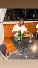 A stylish evening unfolds as Delly enjoys a meal at an upscale restaurant. Seated in a plush orange booth, he savors his food under warm candlelight, creating an intimate and elegant atmosphere. This moment captures the essence of a sophisticated night out. by @delwinbazilme with So Sorry by Lil Baby