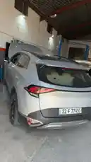A quick tour inside the Wasta Hawkar auto workshop reveals a busy garage with multiple vehicles undergoing service. A silver hatchback is featured prominently with its trunk open, while other cars with hoods up are serviced in the background. Mechanics can be seen working around the shop, which is equipped with professional tools and lifts. The scene captures the everyday operations of a modern car repair facility. by @hawkar_service with Original Sound by hawkar_service