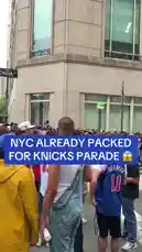 The streets of New York City are completely packed with jubilant fans celebrating the New York Knicks' NBA Championship victory. The camera moves through a massive, energetic crowd of people wearing team jerseys and championship gear, capturing the electric atmosphere of the parade. by @yahoosports with Original Sound by yahoosports