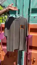 A hand presents a curated collection of graphic t-shirts against a vibrant, graffiti-covered backdrop. The video cycles through various designs, including a stylized tree with a red 'F', a character illustration, a whimsical bear duo, and a castle silhouette. This showcase highlights unique streetwear fashion and artistic apparel. by @ford_fetti with Original Sound by Contains: Can't Touch This - Molly Santana