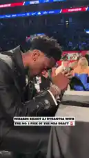 The video captures the emotional and celebratory moment of AJ Dybantsa being selected with the first overall pick in the 2026 NBA Draft by the Washington Wizards. It begins with him praying at a table before his name is announced. Upon hearing his name, he stands up and embraces his family and team representatives on stage, sharing a heartfelt hug with his father. The atmosphere is electric as cameras flash and the crowd erupts in cheers. by @nba with Original Sound by nba